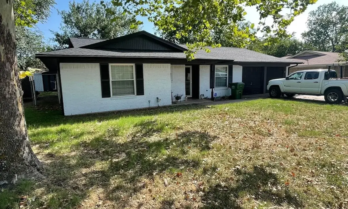 Professional roofing crew working on a residential roof in Conway